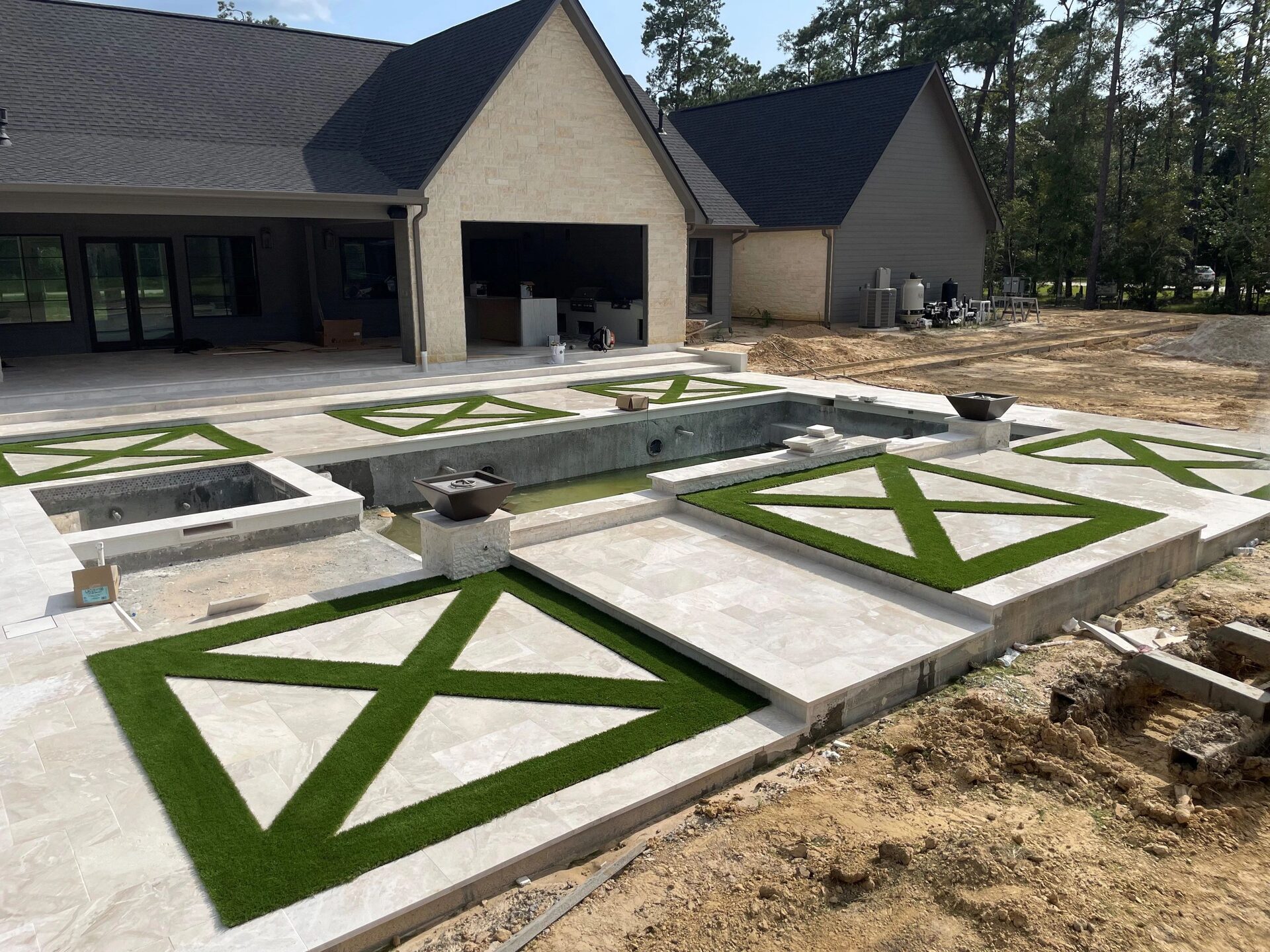 Luxury pool deck with geometric turf inlay panels, Lumberton